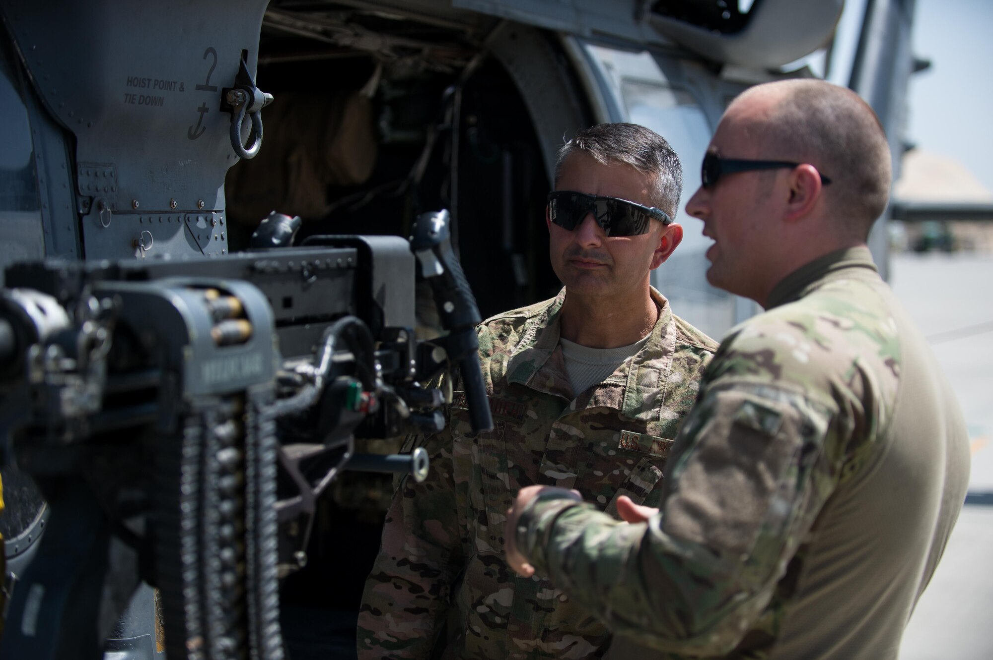 U.S. Air Force Brig. Gen. Dave Julazadeh, 455th Air Expeditionary Wing commander, left, is given a tour of a HH-60 Pave Hawk helicopter by a Special Mission Aviator assigned to the 83rd Expeditionary Rescue Squadron at Bagram Airfield, Afghanistan, July 16, 2015. Julazadeh took part in a training mission with the Aircrew and Guardian Angels of the 83 ERQS to see firsthand how they contribute to the mission in Afghanistan. (U.S. Air Force photo by Tech. Sgt. Joseph Swafford/Released)