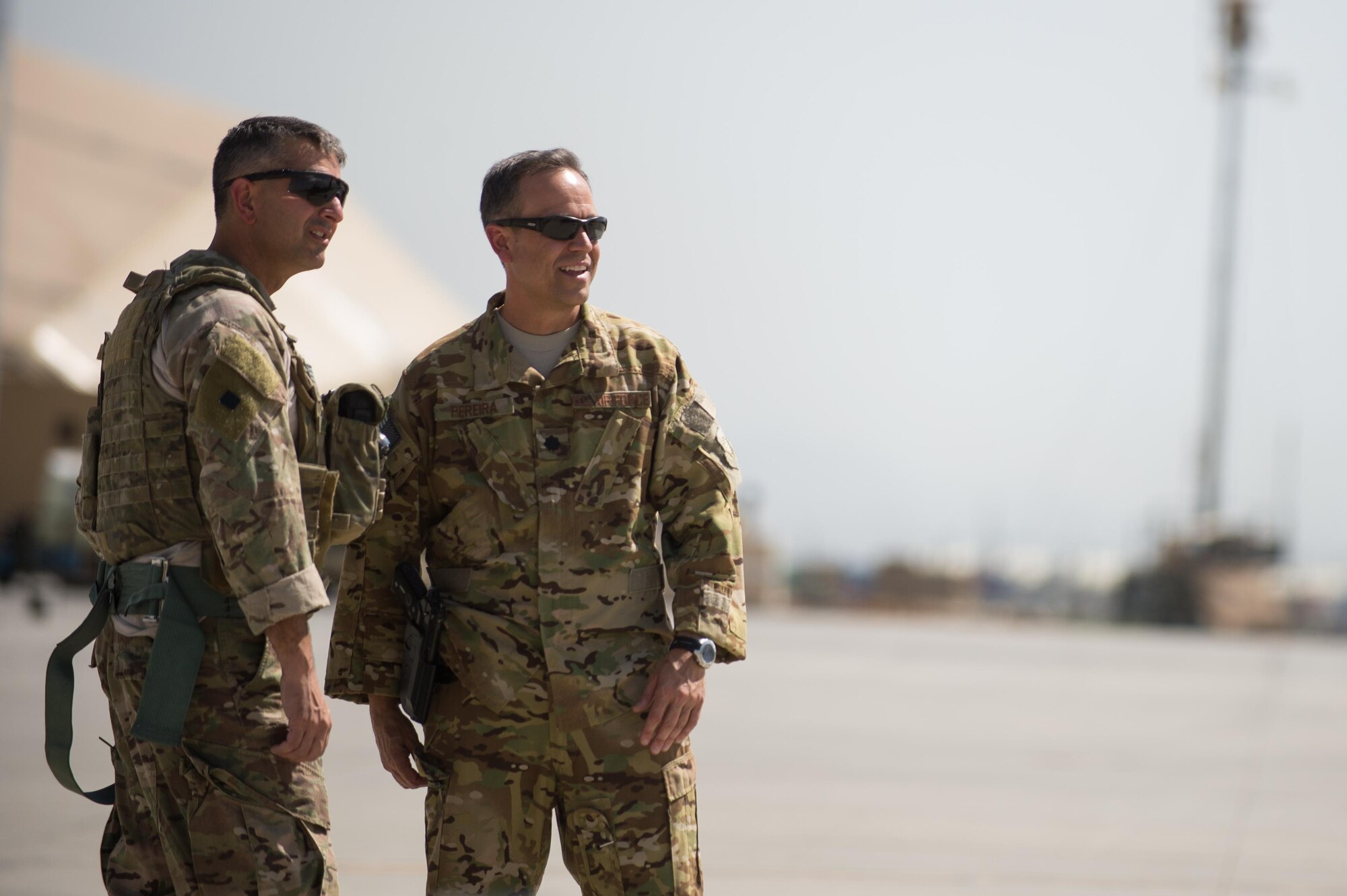 U.S. Air Force Brig. Gen. Dave Julazadeh, 455th Air Expeditionary Wing commander, center, speaks with Lt. Col. Victor Pereira, 83rd Expeditionary Rescue Squadron commander, during an immersion tour at Bagram Airfield, Afghanistan, July 16, 2015. Julazadeh took part in a training mission with the Aircrew and Guardian Angels of the 83 ERQS to see firsthand how they contribute to the mission in Afghanistan. (U.S. Air Force photo by Tech. Sgt. Joseph Swafford/Released)