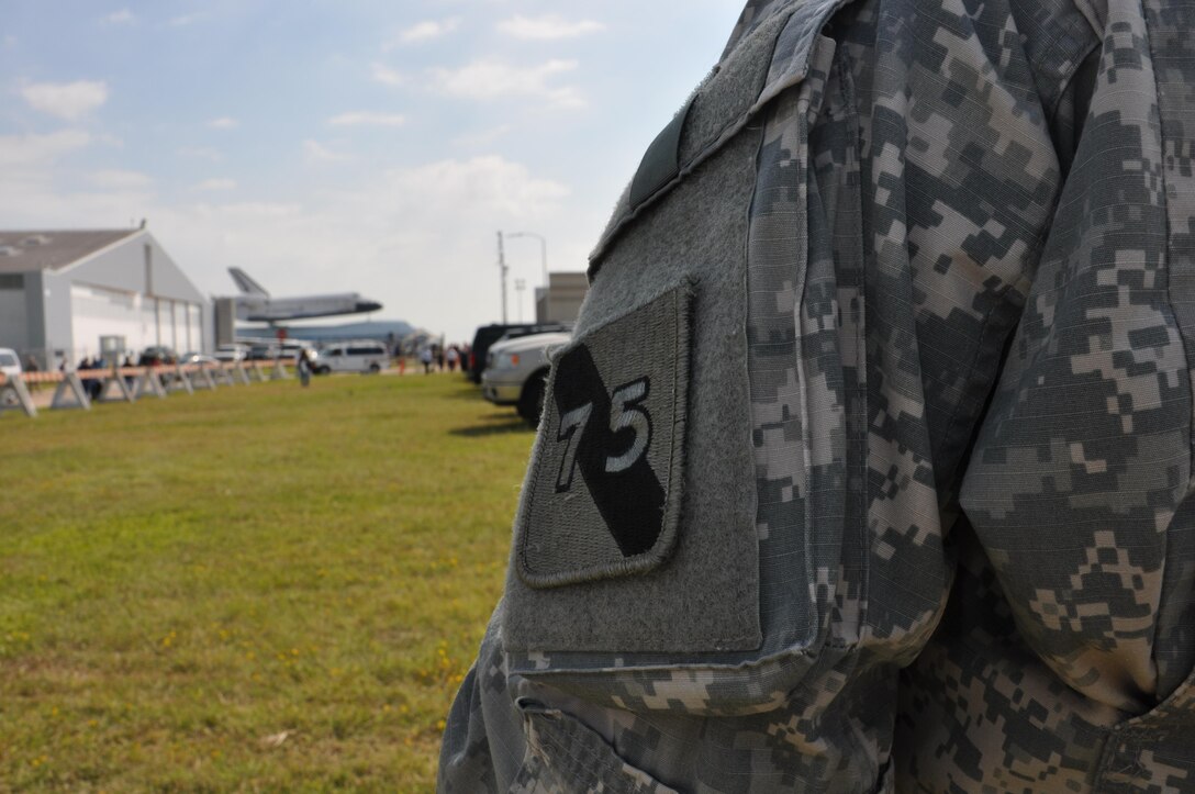 In this image released by the United States Army Reserve, Sgt. 1st Class Robert Evans, Jr. with the 75th Training Command observes the Space Shuttle Endeavour in Houston, Texas, Wednesday, Sept. 19, 2012. The retired spacecraft made a brief stop at the city's Ellington International Airport before being transported to a museum complex in Los Angeles. The 75th is headquartered at the adjacent Ellington Field Joint Reserve Base, and is the senior military headquarters in Houston.  (Photo/75th Training Command, Army Reserve Maj. Adam Collett) 