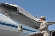 In this image released by the United States Army Reserve, Lt. Col Ana Malkowski with the 75th Training Command observes the Space Shuttle Endeavour in Houston, Texas, Wednesday, Sept. 19, 2012. The retired spacecraft made a brief stop at the city's Ellington International Airport before being transported to a museum complex in Los Angeles. The 75th is headquartered at the adjacent Ellington Field Joint Reserve Base, and is the senior military headquarters in Houston.  (Photo/75th Training Command, Army Reserve Maj. Adam Collett) 