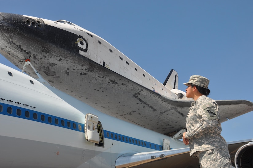 In this image released by the United States Army Reserve, Lt. Col Ana Malkowski with the 75th Training Command observes the Space Shuttle Endeavour in Houston, Texas, Wednesday, Sept. 19, 2012. The retired spacecraft made a brief stop at the city's Ellington International Airport before being transported to a museum complex in Los Angeles. The 75th is headquartered at the adjacent Ellington Field Joint Reserve Base, and is the senior military headquarters in Houston.  (Photo/75th Training Command, Army Reserve Maj. Adam Collett) 