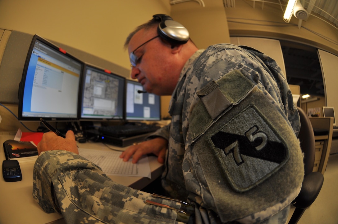 In this image released by the 75th Training Command, Army Reserve soldiers and contractors with the unit’s Southern Division operate a computer-based simulation training exercise in Houston, Texas, Saturday, Oct. 20, 2012. The exercise was part of an effort to demonstrate a system developed by the 75th to allow various military units to conduct certain types of scenario-based ‘war game’ training over computer networks. In this exercise, the unit undergoing the training was located in Louisiana, while one small team – pictured here – transmitted the fictional scenario via network and phone. This format allows units to train in leadership and mission management tasks with a high degree of realism, and a low overall cost.  (Photo/75th Training Command, Army Reserve Maj. Adam Collett) 