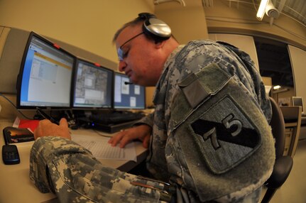 In this image released by the 75th Training Command, Army Reserve soldiers and contractors with the unit’s Southern Division operate a computer-based simulation training exercise in Houston, Texas, Saturday, Oct. 20, 2012. The exercise was part of an effort to demonstrate a system developed by the 75th to allow various military units to conduct certain types of scenario-based ‘war game’ training over computer networks. In this exercise, the unit undergoing the training was located in Louisiana, while one small team – pictured here – transmitted the fictional scenario via network and phone. This format allows units to train in leadership and mission management tasks with a high degree of realism, and a low overall cost.  (Photo/75th Training Command, Army Reserve Maj. Adam Collett) 