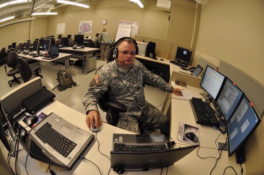 In this image released by the 75th Training Command, Army Reserve Sgt. 1st Class Danial Lisarelli with the unit’s Southern Division operates a computer-based simulation training exercise in Houston, Texas, Saturday, Oct. 20, 2012. The exercise was part of an effort to demonstrate a system developed by the 75th to allow various military units to conduct certain types of scenario-based ‘war game’ training over computer networks. In this exercise, the unit undergoing the training was located in Louisiana, while one small team transmitted the fictional scenario via network and phone from Houston. This format allows units to train in leadership and mission management tasks with a high degree of realism, and a low overall cost.  (Photo/75th Training Command, Army Reserve Maj. Adam Collett) 