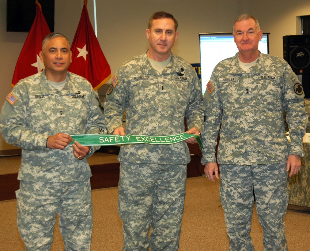 The 75th Division Commander Maj. Gen Eldon Regua and Division Safety Officer Chief Warrant Officer Robert Shultz, accepts the Army Safety Excellence Streamer from Maj. Gen. James Sholar, Deputy Commanding General, United States Army Reserve Command.  The 75th Division earned the award by achieving 12 consecutive months without a Soldier or unit at fault Class A or B accident.  