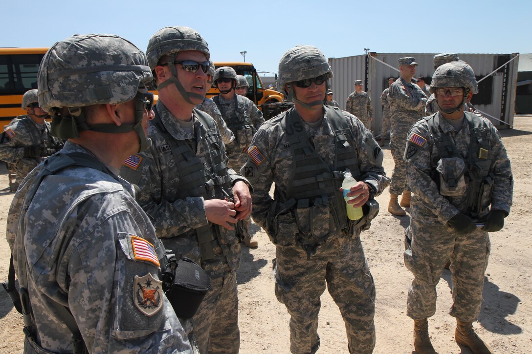 (from left) U.S. Army Maj. Gen. Paul Benenati, Deputy Commanding General Support, First Army, Brig. Gen. Andrew Bassford, Deputy Commanding General of the 88th Regional Support Command, Brig. Gen. Bruce Hackett, Commanding General of the 78th Training Division, and Command Sgt. Maj. Jay Thomas, Command Sergeant Major of the 78th Training Division, discuss improvements for the Combat Support Training Exercise (CSTX) during Distinguished Visitors (DV) day at Fort McCoy, Wis., June 19, 2015. DV day is facilitated by the 78th Training Division's Joint Visitors Bureau to provide general officers the opportunity to view personnel under their command during Combat Support Training Exercise 78-15-02.