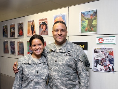 Lt. Col. Andreas J. McGhee, Equal Opportunity Program manager, Army Reserve 84th Training Command, Fort Knox, Ky., shares a moment with his daughter, 1st Lt. Andria Kimberly, an Army Reservist with the 801st Combat Support Hospital, Indianapolis, at the Command's Headquarters March 14, 2015. (U.S. Army Photo by Sgt. 1st Class Clinton Wood, 84th Training Command Public Affairs/Released)