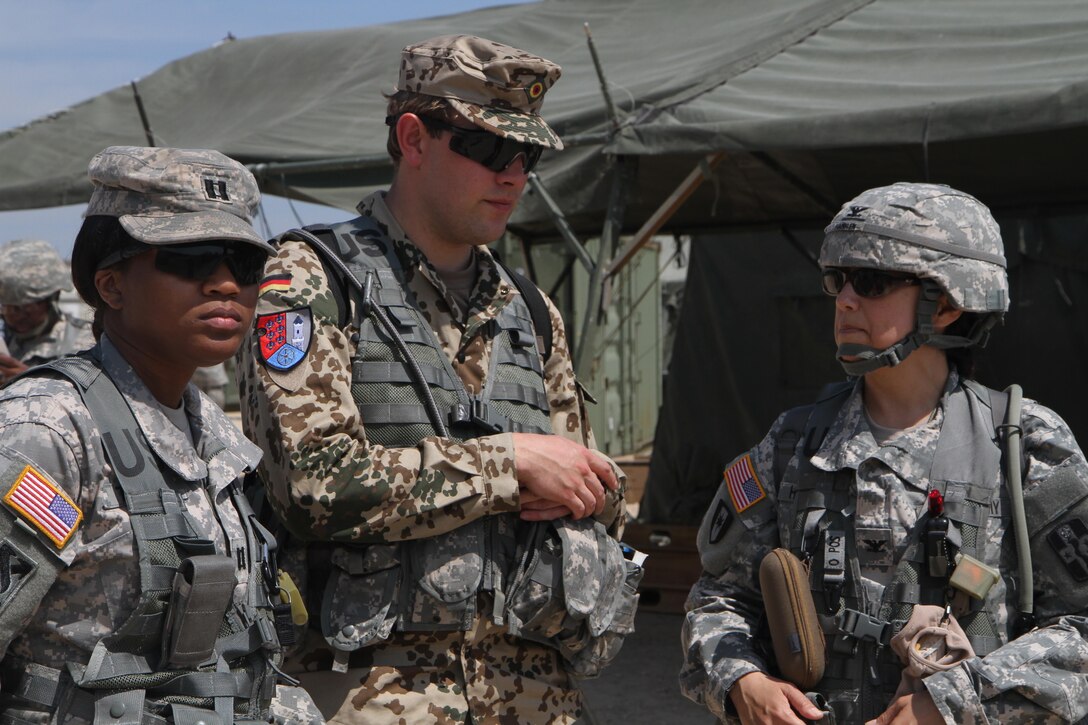 U.S. Army Col. Estela Hamblen, the 94th Combat Support Hospital commander, Capt. Renee Taylor, an observer-coach/trainer with the 3rd Brigade, Gulf Division, 75th Training Command, and German Capt. Steffen Drewes wait for a UH-60 Black Hawk to medically evacuate (medevac) casualties at Fort McCoy, Wis., June 8, 2015. Hamblen, Taylor and Drewes observed a medevac training exercise with 94th Combat Support Hospital Soldiers during Combat Support Training Exercise (CSTX) 78-15-02. (U.S. Army photo by Spc. Brieanna Ogletree/Released)