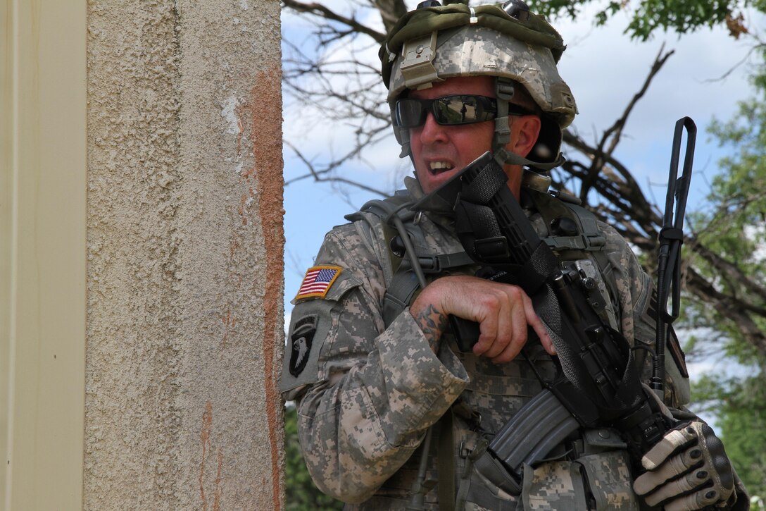 A U.S. Army Soldier assigned to the 94th Military Police Company, waits behind cover during training at a Military Operation on Urbanized Terrain site at Fort McCoy, Wis., June 14, 2015. Soldiers of the 94th MP Company conducted training to improve unit readiness during Combat Support Training Exercise 78-15-02. The 78th Training Division’s Combat Support Training Exercise is a multi-component and joint endeavor which is integrated with Global Medic and QLLEX and occurring simultaneously at seven installations nationwide