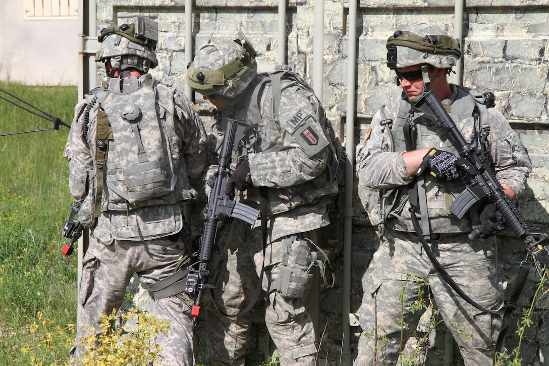 U.S. Army Soldiers assigned to the 94th Military Police Company use improvised cover during training at a Military Operation on Urbanized Terrain site at Fort McCoy, Wis., June 14, 2015. Soldiers of the 94th MP Company conducted training to improve unit readiness during Combat Support Training Exercise 78-15-02. The 78th Training Division’s Combat Support Training Exercise is a multi-component and joint endeavor which is integrated with Global Medic and QLLEX and occurring simultaneously at seven installations nationwide.