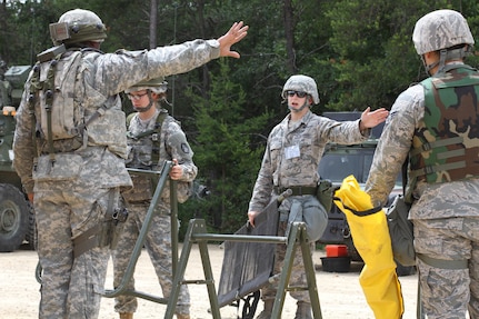 U.S. Army Soldiers assigned to the 46th Chemical Company speak with Senior Airman Derek R. Aalerud, assigned to the 439th Civil Engineering Squadron, to establish hot and cold lines within the contamination control area during a simulated chemical decontamination training exercise at Tactical Training Base Patriot on Fort McCoy, Wis., June 18, 2015. Soldiers and Airmen worked together to improve mission readiness as part of Combat Support Training Exercise (CSTX) 78-15-02. The 78th Training Division’s CSTX is a multi-component and joint endeavor which is integrated with Global Medic and QLLEX and occurring simultaneously at seven installations nationwide.