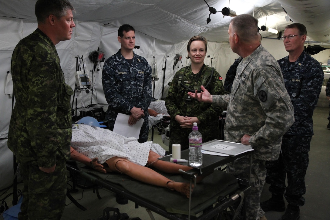 U.S. Army Maj. Gen. Scottie D. Carpenter, commanding general of the 84th Training Command, discusses differences between medical procedures with sailors of the Royal Canadian Navy at Fort McCoy, Wis., June 17, 2015. Carpenter visits to oversee the Combat Support Training Exercise 78-15-02. The 78th Training Division’s CSTX is a multi-component and joint endeavor which is integrated with Global Medic and QLLEX and occurring simultaneously at seven installations nationwide. (U.S. Army Photo by Spc. Jermaine Sullivan)