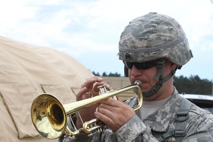 U.S. Army Sgt. 1st Class Steve Hassinger, a pianist for the 78th Army Band, plays during the grand opening of the United Service Organization (USO) on Forward Operating Base Freedom at Fort McCoy, Wis., June 20, 2015. The USO hosted a luncheon to support service members during Combat Support Training Exercise (CSTX) 78-15-02. The 78th Training Division’s CSTX is a multi-component and joint endeavor which is integrated with Global Medic and QLLEX and occurring simultaneously at seven installations nationwide.