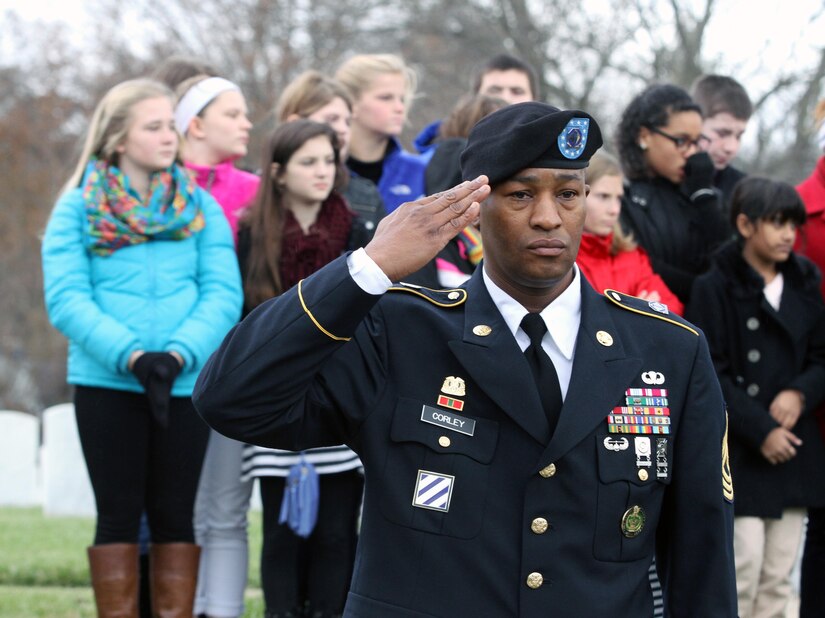 Army Reserve 1st Sgt. Christopher N. Corley of Charlotte, N.C., Headquarters and Headquarters Company, 84th Training Command, Fort Knox, Ky., salutes during the Zachary Taylor National Cemetery wreath laying ceremony Monday, Nov. 24, 2014, in Louisville, Ky. Standing behind Corley, who was a member of the Company's Honor Platoon, was the T.K. Stone Middle School, Elizabethtown, Ky., student council. The school is the Command's Partnership in Education School. (Photo by Clinton Wood, 84th TC Public Affairs)