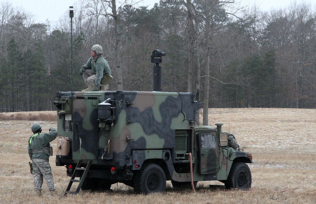 Sgt. Hubbard Hoyt and Sgt. Terry Potts of the 310th Chemical Company setup a Biological Integrated Detection System (BIDS) at Fort A.P. Hill, Va., Jan. 14, 2015. The 310th is sharpening their threat-detection skills in a cold-weather environment while at the 78th Training Division's Warrior Exercise (WAREX) 78-15-01.