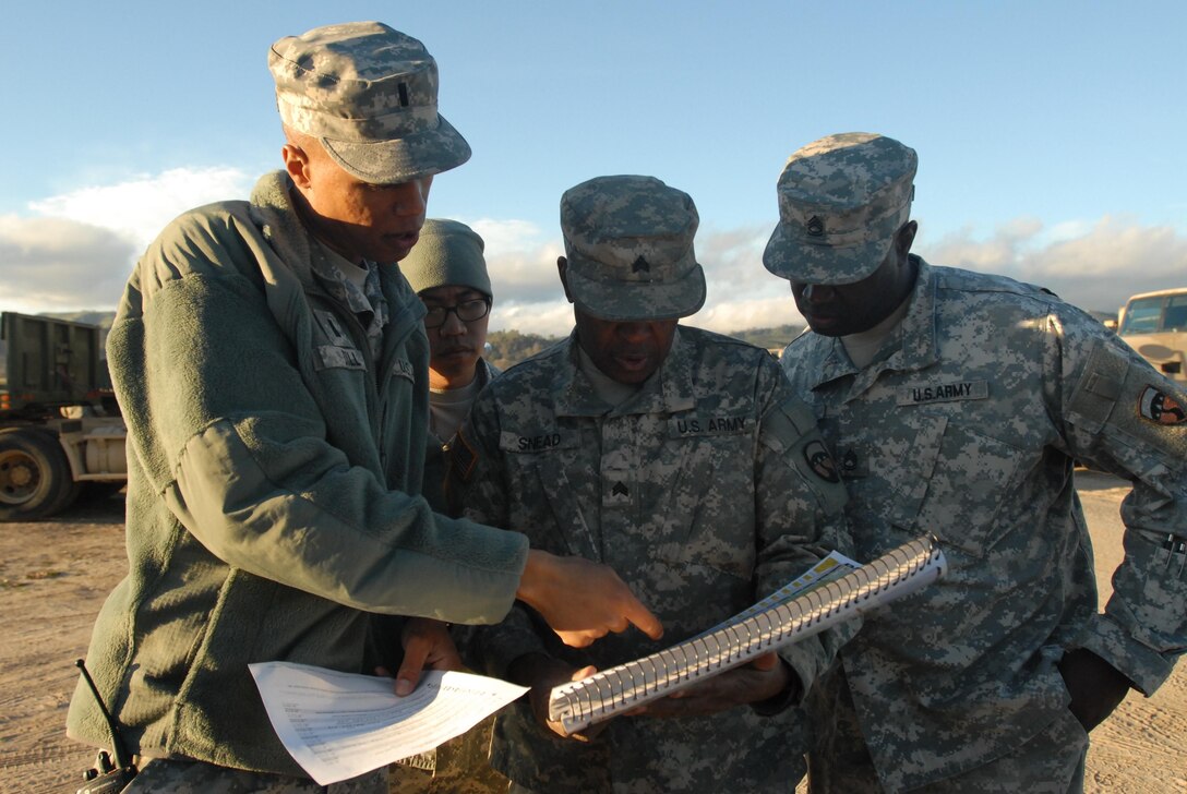 First Lt. Elliott Dill (left), officer in charge of movement and 2nd platoon leader with the 250th Transportation Company in El Monte, Calif., reviews the route map with his convoy commander, Sgt. 1st Class Jerry Lubin (right) and two of his convoy drivers on Feb. 6, 2015, at Fort Hunter Liggett, Calif., prior to a long-haul convoy mission to Fort Lewis, Wash., during Nationwide Move 2015 (NWM 15). NWM 15 is an Army Reserve approved functional training exercise designed to provide Reserve Component transportation and support units with valuable, realistic training, by conducting operations in support of Continental United States (CONUS) activities.
