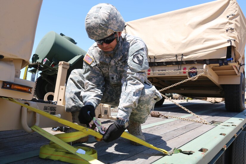 Spc. Jose Pastrana, a Caguas, Puerto Rico, native, prepares cargo for offload after a two-week, 2,700-mile convoy operation from Fort Riley, Kan., to Fort Hunter Liggett, Calif., on July 17. The convoy operation was part of Nationwide Move 15, an annual Army Reserve approved functional training exercise designed to provide Reserve component transportation units with valuable, realistic training by conducting real-world operations in support of continental United States activities. (U.S. Army Photo by Sgt. Victor Ayala, 210th MPAD)
