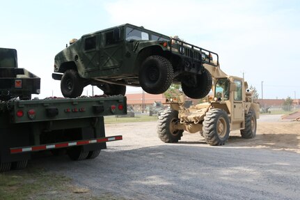 A Humvee gets unloaded at Fort Drum, N.Y, May 29 following a successful convoy of the 846th Transportation Company, 812th Transportation Battalion, 518th Sustainment Brigade. The convoy covered over 600 miles and transported 53 pieces of equipment from Lynchburg, Va. to Fort Drum. The transportation movement was part of Exercise Nationwide Move 15. The annual exercise is an Army Reserve approved functional training exercise designed to provide Reserve Component transportation units with valuable, realistic training, by conducting real-world operations in support of Continental United States (CONUS) activities. (Official US Army Reserve photo by Pfc. Dakota Price, 210th Mobile Public Affairs Detachment)