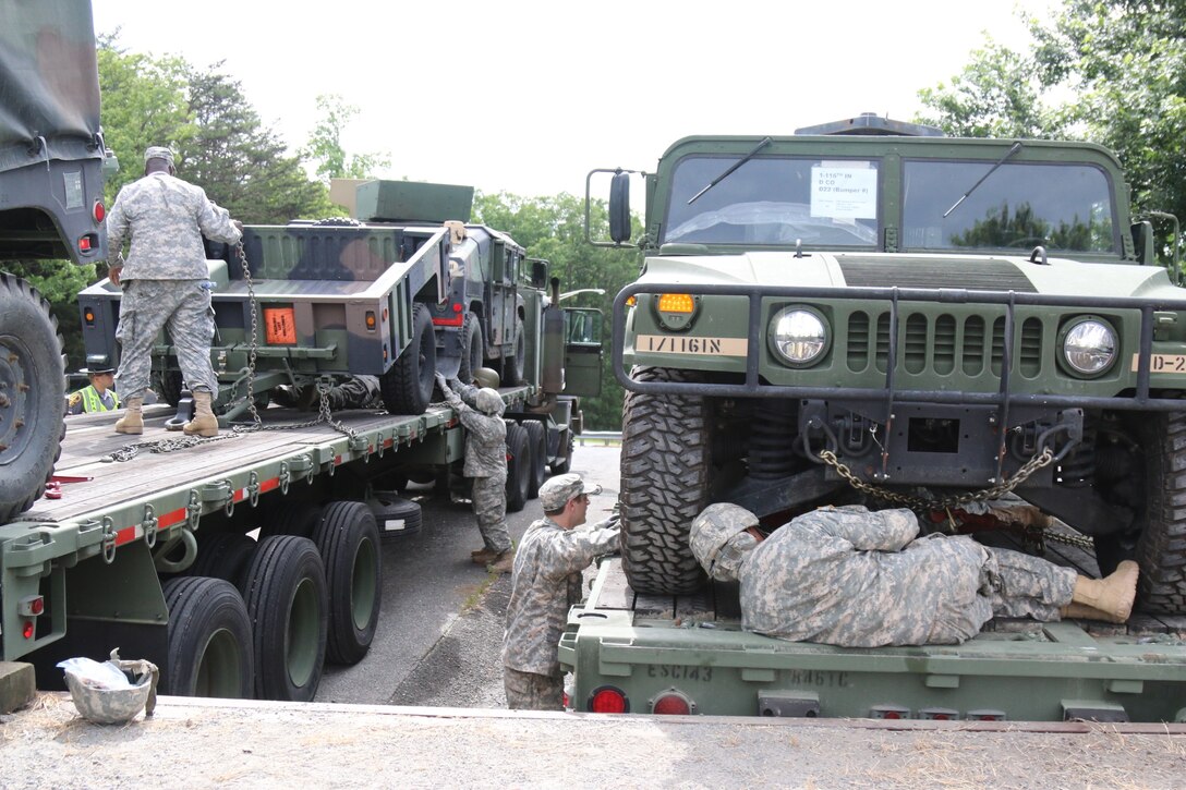 Army Reserve Soldiers of the 846th Transportation Company, 812th Transportation Battalion, 518th Sustainment Brigade work together to secure equipment during a recent transportation exercise involving moving vehicles more than 600 miles from Lynchburg, Virginia to Fort Drum, New York.  The movement was part of Exercise Nationwide Move 15.  NWM is an annual Army Reserve approved functional training exercise designed to provide Reserve Component transportation units with valuable, realistic training, by conducting real-world operations in support of Continental United States (CONUS) activities. (Official US Army Reserve photo by Pfc. Dakota Price, 210th Mobile Public Affairs Detachment)