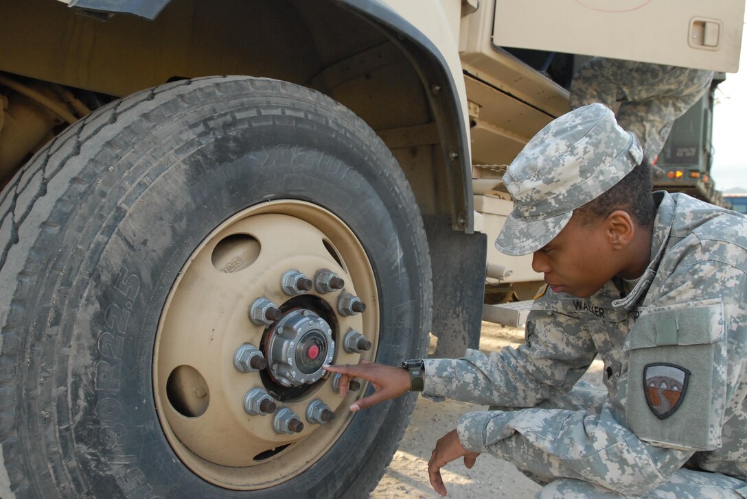 Spc. Elizabeth Walker, a motor transport operator with the 250th Transportation Company in El Monte, Calif., performs preventive maintenance, checks and services on her vehicle Feb. 6, 2015, at Fort Hunter Liggett, Calif., prior to a long-haul convoy mission to Fort Lewis, Wash., during Nationwide Move 2015 (NWM 15). NWM 15 is an Army Reserve approved functional training exercise designed to provide Reserve Component transportation and support units with valuable, realistic training, by conducting operations in support of Continental United States (CONUS) activities.