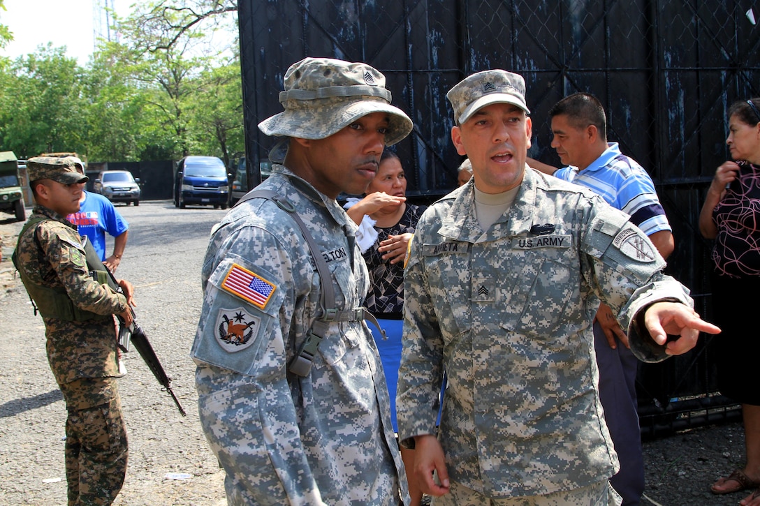 Army Sgt. David N. Arrieta, a Houston native with the 451st Civil Affairs Battalion, gives a situation report to Sgt. 1st Class Thaddeus U. Brazelton, also from the 451st Civil Affairs Battalion, during a Medical Readiness Training Exercise as part of Beyond the Horizon, May 11. BTH is a combined medical and engineer mission that provides humanitarian assistance to the people of El Salvador. (U.S. Army photo by Sgt. Rigo Cisneros)