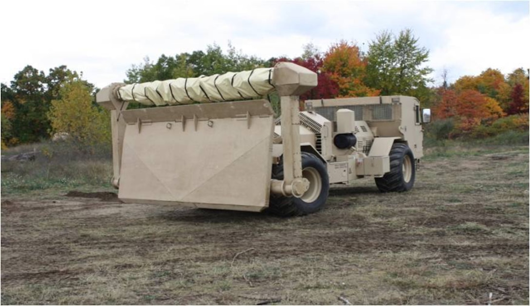 An M1271 Medium Flail Mine Clearing Vehicle is equipped with a rotating flail and 72 chains with fist-sized balls, or hammers, at the end of the chains. As the vehicle drives backwards over the designated area, the flail rotates and the chains dig into the ground tearing mines apart or detonating them. The driver is protected by a deflector shield of armored steel, protecting the both the driver and vehicle against blast pressure and mine fragments. (Courtesy photo/USARC G4)