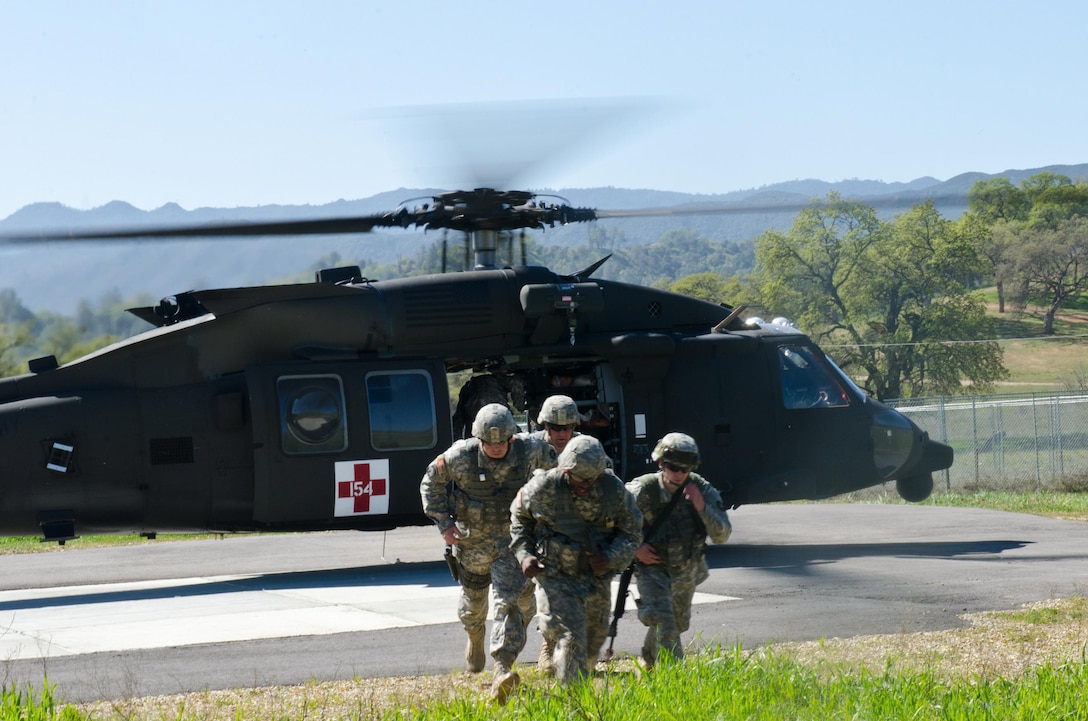 U.S. Army Reserve Soldiers with the 456th Area Support Medical Company out of Somersworth, N.H., and the 912th Forward Surgical Team out of Cranston, R.I., team up with Naval corpsmen from the Expeditionary Medical Facility out of Dallas/Forth Worth at the USAR Combat Support Training Exercise in Fort Hunter Liggett, Calif., March 7, 2015. The Soldiers and Sailors collaborated with medical aviation Soldiers in a real-world scenario exercise to booster their skills for deployment operations. (U.S. Army Reserve photo by Brian Godette/released)
