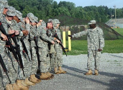 Sgt. 1st Class Anthony Lacy, a U.S. Army Reserve Officer Training Course instructor at the University of Cincinnati, guides cadets of Company A, 6th Regiment, through preparations for their weapons qualification at Blair Range, Fort Knox, Ky., July 11, 2015. Weapon range safety is among the many responsibilities senior noncommissioned officers carry, ensuring these future leaders learn by their example. (U.S. Army photo by Sgt. Javier Amador)