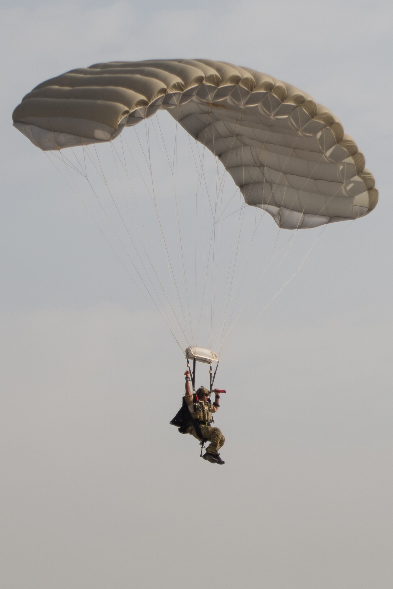 A U.S. Air Force Pararescueman with a Guardian Angel team assigned to the 83rd Expeditionary Rescue Squadron parachutes to the ground during High Altitude Low Opening jump training at Bagram Airfield, Afghanistan, July 18, 2015. The 83rd ERQS mission is to rescue, recover, and return American or allied forces in times of danger or extreme duress. (U.S. Air Force photo by Tech. Sgt. Joseph Swafford/Released)