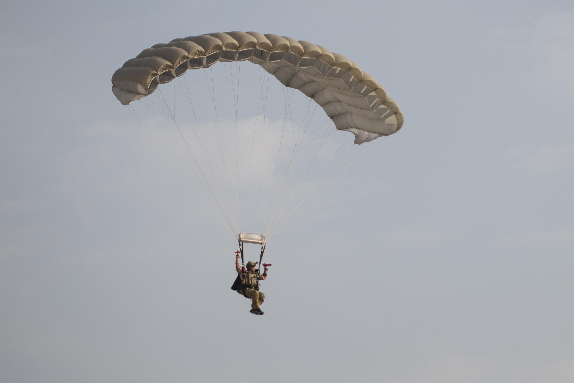 A U.S. Air Force Pararescueman with a Guardian Angel team assigned to the 83rd Expeditionary Rescue Squadron parachutes to the ground during High Altitude Low Opening jump training at Bagram Airfield, Afghanistan, July 18, 2015. The 83rd ERQS mission is to rescue, recover, and return American or allied forces in times of danger or extreme duress. (U.S. Air Force photo by Tech. Sgt. Joseph Swafford/Released)