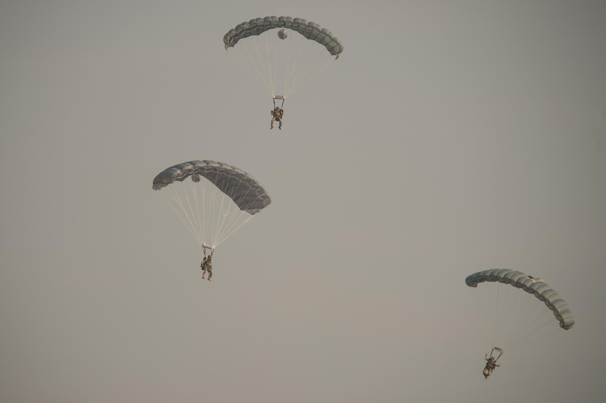 U.S. Air Force Pararescuemen as part of a Guardian Angel team assigned to the 83rd Expeditionary Rescue Squadron parachute to the ground during High Altitude Low Opening jump training at Bagram Airfield, Afghanistan, July 18, 2015. The 83rd ERQS mission is to rescue, recover, and return American or allied forces in times of danger or extreme duress. (U.S. Air Force photo by Tech. Sgt. Joseph Swafford/Released)