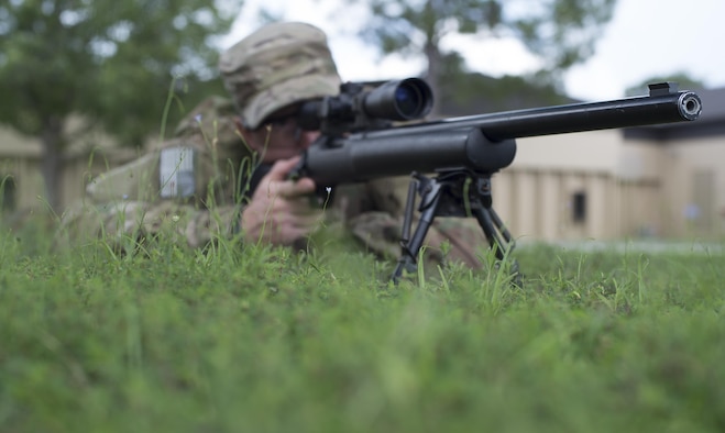 Staff Sgt. Joseph Crotty, the 822d Base Defense Squadron NCO in charge of standards and evaluations, gazes down the sights of his M24 Sniper Weapon System while in the prone position July 2, 2015, at Moody Air Force Base, Ga. Crotty and Senior Airman Phillip Hopkins, the 822d Base Defense Squadron fireteam leader, attended the nine-week Royal Air Force's Basic Sniper Course to develop their knowledge and skills. (U.S. Air Force photo/Staff Sgt. Eric Summers Jr.)