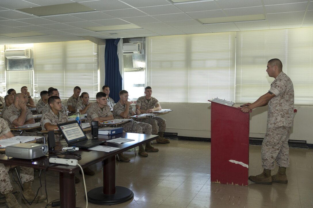 Staff Sgt. Salomen Cumpian, a motor transport maintenance chief with Marine Tactical Air Command Squadron 18, with 1st Marine Wing Aircraft, III Marine Expeditionary Unit, lectures Marines during a career progression class during the Futenma Corporal’s Course, July 15, 2015, aboard Marine Corps Air Station Futenma, Okinawa, Japan, Marine Corps Installations Pacific. This is the fifth course of this year. The class started July 13, 2015, and is scheduled to graduate July 31, 2015. 