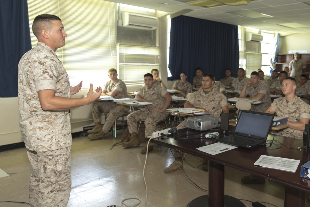Staff Sgt. Neil Foose Jr., deputy director of Corporal’s Course aboard Marine Corps Air Station Futenma, Okinawa, Japan, Marine Corps Installations Pacific, debriefs Marines after they received a class on career progression during the Futenma Corporal’s Course, July 15, 2015, aboard MCAS Futenma. This is the fifth course of this year. The class started July 13, 2015, and is scheduled to graduate July 31, 2015. Foose from Rochester, New York, is also the ground and electronics maintenance chief with Marine Air Control Squadron 4, 1st Marine Air Wing, III Marine Expeditionary Unit. 