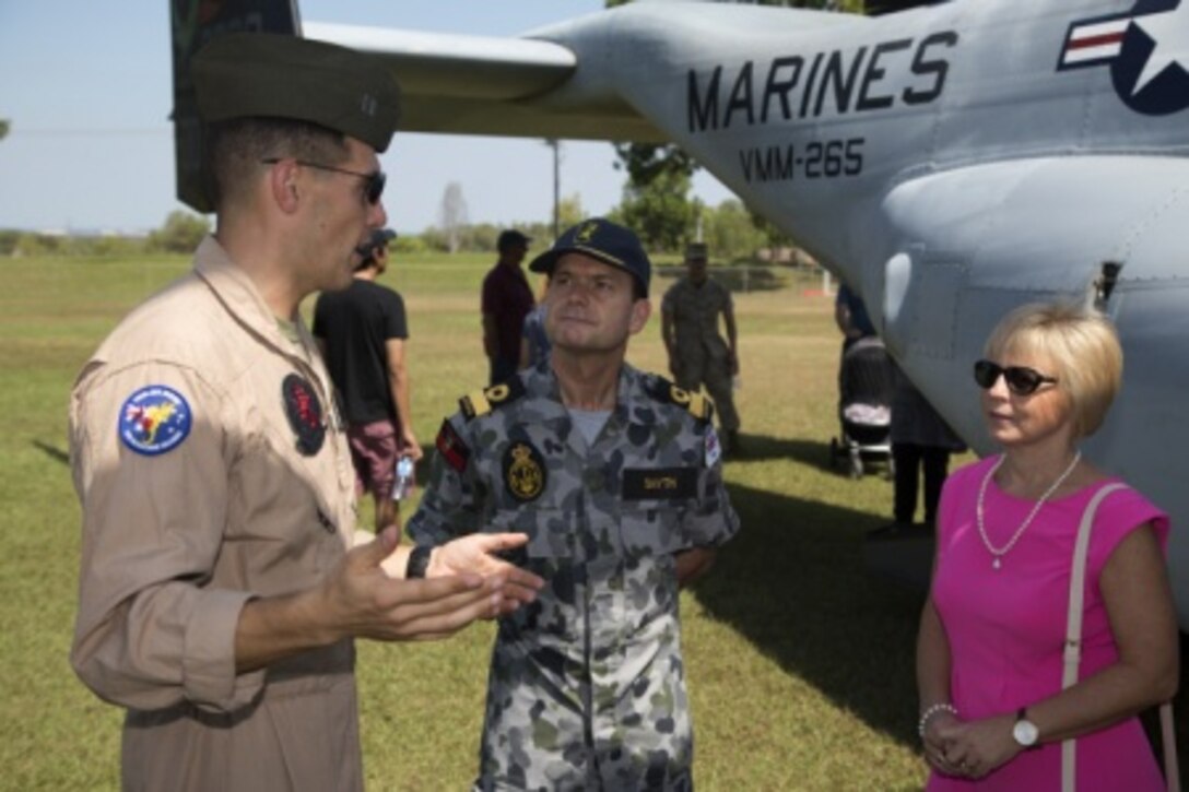 U.S. Marine Corps Capt. Vic Bockman, left, a MV-22B Osprey pilot from Marine Medium Tiltrotor Squadron 265, gives a tour of an MV-22B Osprey to Royal Australian Navy Commodore Brenton Smyth, center, commander of Headquarters Northern Command, and Karen Smyth, during the opening ceremony for exercise Talisman Sabre 15 at the Darwin Showground, Darwin, Northern Territory, Australia, July 5. The sixth iteration of Talisman Sabre will focus on joint training of a Combined Task Force of U.S. and Australian forces in a mid-intensity, high-end operation, incorporating interagency participation. Conducting land, sea, and air training during the exercise, the U.S. and Australian forces will feature 21 ships, including the U.S. Navy aircraft carrier USS George Washington (CVN 73), more than 200 aircraft, and three submarines.