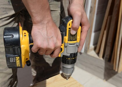 U.S. Air Force Senior Airman Carl Vanlandingham, 455th Expeditionary Civil Engineer Squadron structural journeyman, drills a screw into a handmade crate he made July 16, 2015, at Bagram Airfield, Afghanistan. Vanlandingham builds projects that are used to support the BAF mission such as crates, platforms and more. (U.S. Air Force photo by Senior Airman Cierra Presentado/Released)