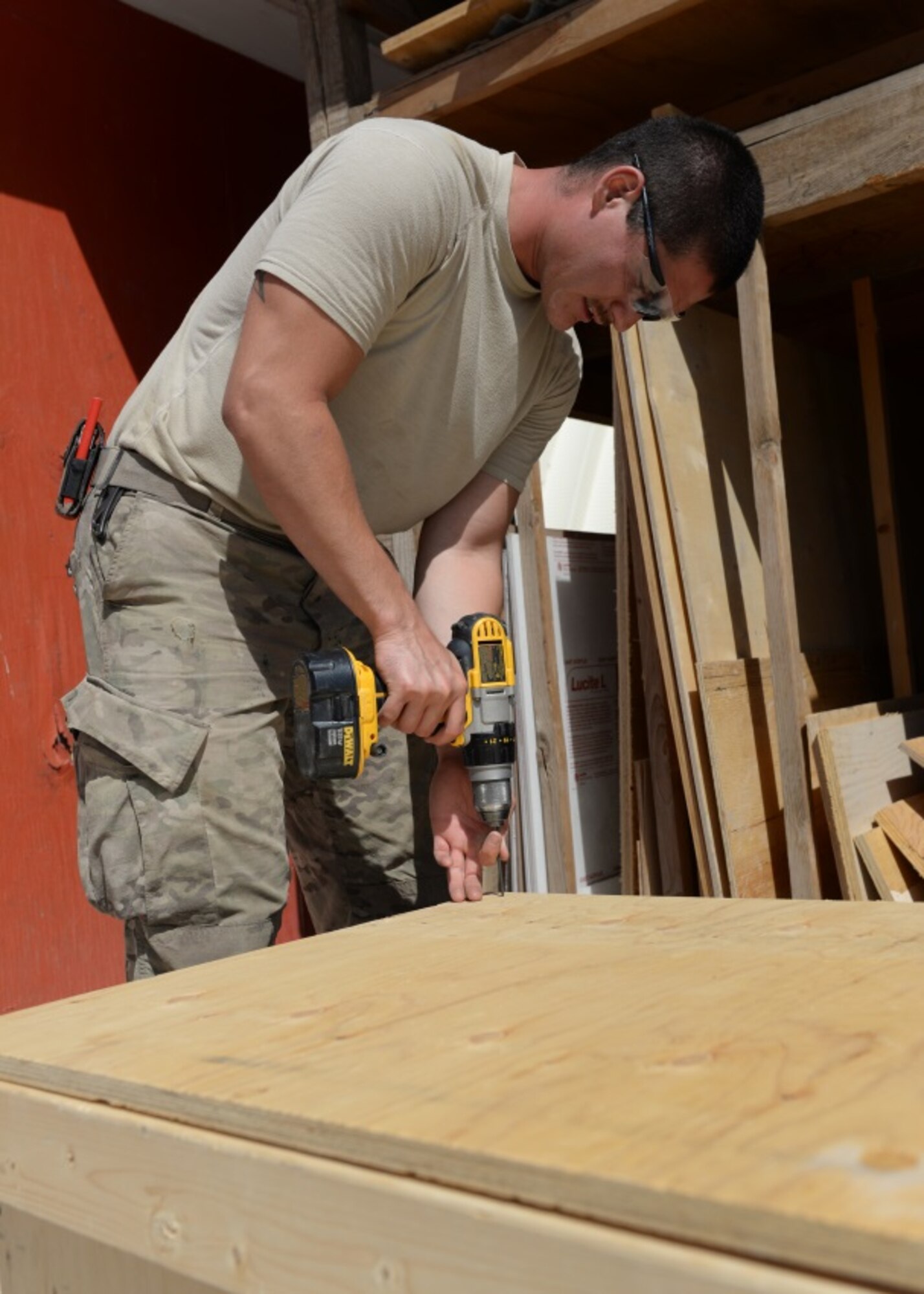 U.S. Air Force Senior Airman Carl Vanlandingham, 455th Expeditionary Civil Engineer Squadron structural journeyman, drills a screw into a handmade crate he made July 16, 2015, at Bagram Airfield, Afghanistan. Vanlandingham builds projects that are used to support the BAF mission such as crates, platforms and more. (U.S. Air Force photo by Senior Airman Cierra Presentado/Released) 
