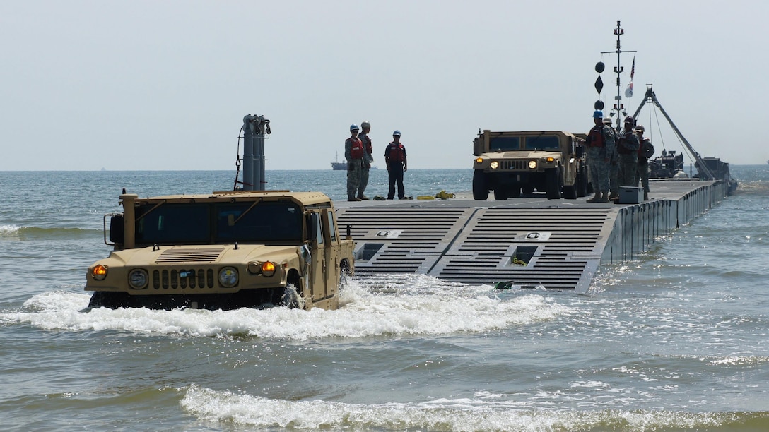 U.S. Marines from the 3rd Marine Expeditionary Force drive High Mobility Multipurpose Wheeled Vehicles (HMMWV) to the beach from a Causeway ferry operated by the 331st Transportation Company at Anmyeon Beach, Republic of Korea, during Exercise Combined Joint Logistics Over-the-Shore (LOTS) 2015.  CJLOTS 2015 is an exercise designed to train U.S. and ROK service members to accomplish vital logistical measures in a strategic area while strengthening communication and cooperation in the U.S.-ROK Alliance.  
