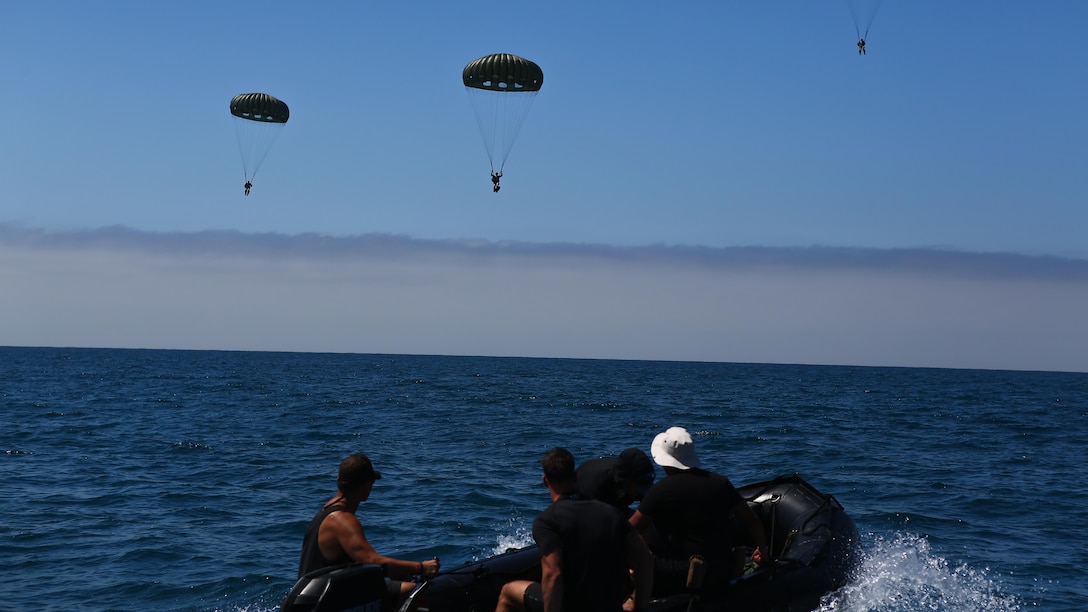 Marines assigned to Company A, 1st Marine Reconnaissance Battalion, 1st Marine Division, perform parachute jumps into the ocean at Marine Corps Base Camp Pendleton, California, July 14, 2015.  The Marines and Sailors conducted low-level static-line parachute operations with intentional water landings to make insertions, where other means such as boats or high-altitude parachute jumps may not be available.