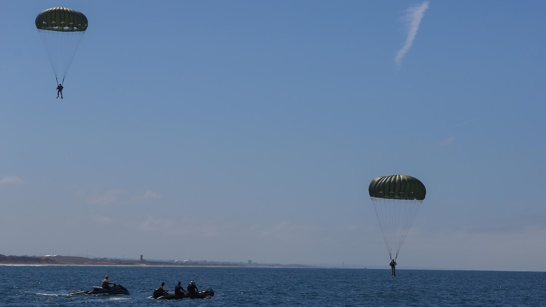 Marines assigned to Company A, 1st Marine Reconnaissance Battalion, 1st Marine Division, perform parachute jumps into the ocean at Marine Corps Base Camp Pendleton, California, July 14, 2015.  The Marines and Sailors conducted low-level static-line parachute operations with intentional water landings to make insertions, where other means such as boats or high-altitude parachute jumps may not be available.