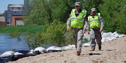 Army Sgt. Sean Windsor and Army Spc. Joseph Scanlan, of the North Dakota National Guard’s 164th Engineering Battalion of Minot, perform levee patrols in one section of more than 20 miles worth of levees from Minot to Burlington that the Guard is patrolling. Soldiers walk the levees to inspect for any damages that may impact structural integrity, as well as provide a security presence along to river to discourage theft or vandalism.