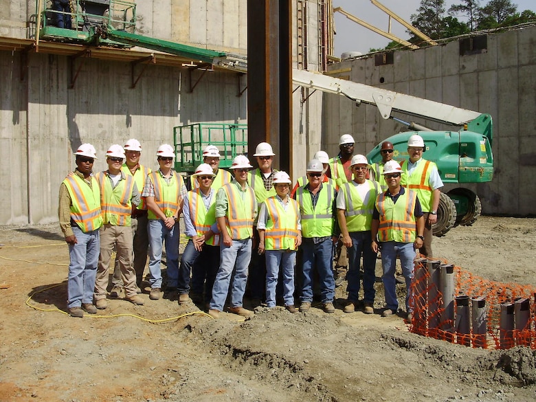 Members of Fort Benning’s Project Delivery Team coalesce after the first piece of structural steel was placed at the site April 9, 2012.      