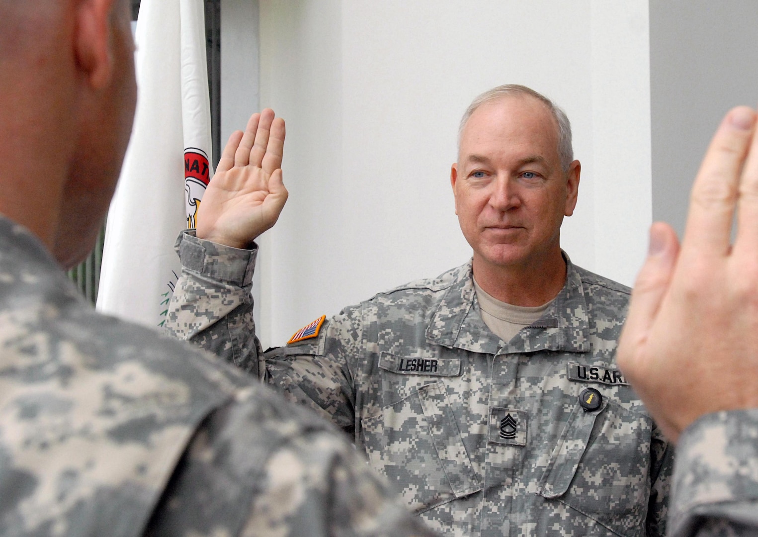 Army Master Sgt. Leland Lesher, the Army National Guard force protection branch noncommissioned officer in charge and an Illinois Guard member, swears the oath of extension and enlistment during a small ceremony at the Army National Guard Readiness Center in Arlington, Va., June 7, 2011. Lesher first enlisted in the Marine Corps in 1970 and switched to the Guard after returning home from Vietnam. Lesher is one of the last active-duty Guard members who has service time in Vietnam.