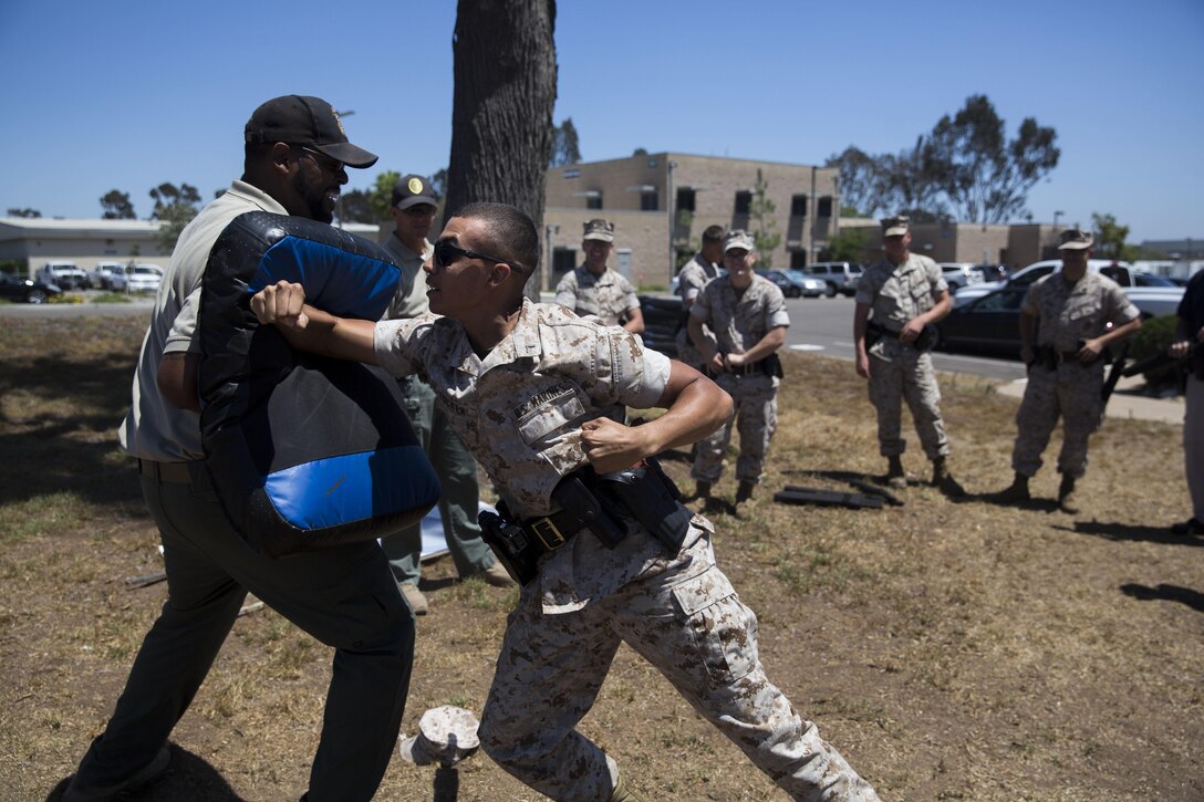 Private First Class Anthony Tucker, a military police officer with the Provost Marshals Office (PMO), practices horizontal elbow strikes during the escalation of force segment of their annual Taser training aboard MCAS Miramar, California, July 15. Tucker and other law enforcement personnel familiarized themselves with the operation and employment of nonlethal weapons, to include the Taser X26. (U.S. Marine Corps photo by Sgt. Brian Marion/Released)
