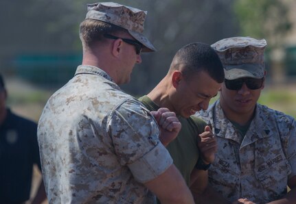 Private First Class Anthony Tucker, a military police officer with the Provost Marshals Office (PMO), receives a 50,000-volt charge from a Taser X26 during annual Taser training aboard Marine Corps Air Station Miramar, California, July 15. Personnel endured a charge from the Taser X26 for their initial training with the Taser. (U.S. Marine Corps photo by Sgt. Brian Marion/Released)