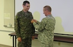 Visiting Soldier is pinned with U.S. rank as training gets underway at Professional Education Center in July, 2015.