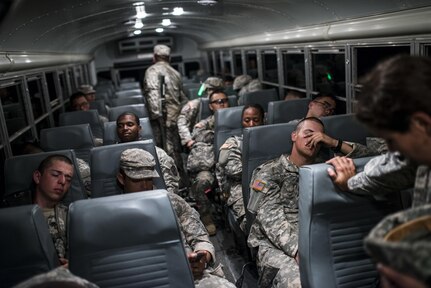 U.S. Army Reserve Combat Engineer Soldiers from the 374th Engineer Company (Sapper), headquartered in Concord, Calif., take a break on a bus after completing a night land navigation course through the hills and mountains of Camp San Luis Obispo Military Installation, Calif., July 15, during a two-week field exercise known as a Sapper Leader Course Prerequisite Training. The land navigation course began after dark and most Soldiers didn't finish until after midnight after trekking for miles through the steep California hills. The unit is grading its Soldiers on each event to determine which ones will earn a spot on a "merit list" to attend the Sapper Leader Course at Fort Leonard Wood, Mo. (U.S. Army photo by Master Sgt. Michel Sauret)