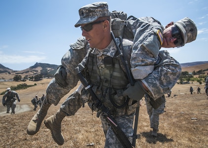 Staff Sgt. Todd Hunnefeld, U.S. Army Reserve combat engineer platoon sergeant for the 374th Engineer Company (Sapper), headquartered in Concord, Calif., carries a "wounded" Soldier during a patrol training July 18 as part of a two-week field training exercise known as a Sapper Leader Course Prerequisite Training at Camp San Luis Obispo Military Installation, Calif. The unit is grading its Soldiers on various events to determine which ones will earn a spot on a "merit list" to attend the Sapper Leader Course at Fort Leonard Wood, Mo. (U.S. Army photo by Master Sgt. Michel Sauret)