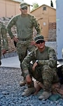 Army Sgt. Jared Henkle and Army Spc. Tyler Parker-Bellinger, both truck
drivers with Company E, 1st Battalion, 133rd Infantry Regiment, Task Force
Ironman, a part of the Iowa National Guard's 2nd Brigade Combat Team, 34th
Infantry Division, Task Force Red Bulls, listen to a mission brief June 6,
2011, on Forward Operating Base Mehtar Lam, Afghanistan, shortly before going
on a convoy. The pair recently found themselves resupplying soldiers from the
133rd who were under heavy fire in Nuristan province.