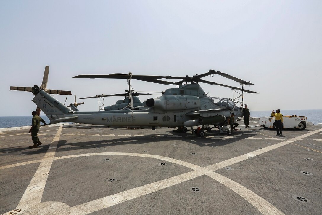 U.S. Marines and Sailors relocate an AH-1Z Viper from the “Greyhawks” of Marine Medium Tiltrotor Squadron 161 (Reinforced), 15th Marine Expeditionary Unit, on the flight deck of the amphibious transport dock ship USS Anchorage (LPD 23). The “Greyhawks” are the aviation combat element of the 15th MEU, and embarked aboard the ships of the Essex Amphibious Ready Group, are deployed in support of maritime security operations and theater security cooperation efforts in the U.S. 5th Fleet area of operations. (U.S. Marine Corps photo by Sgt. Steve H. Lopez/Released)